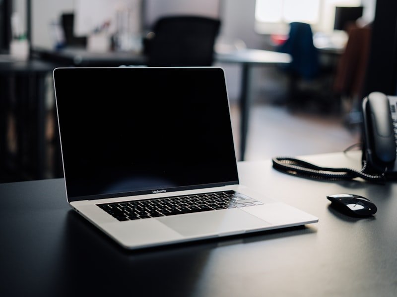 A virtual assistant working on a laptop in a home office setup